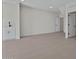 Large open room featuring tile floors, neutral walls, and an adjoining wet bar setup at 7448 S 75Th Ln, Laveen, AZ 85339