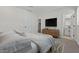 Bright bedroom with modern furniture, TV, and ensuite bathroom at 7448 S 75Th Ln, Laveen, AZ 85339