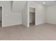 Empty bedroom featuring tile floors, neutral walls, closet and access to more rooms at 7448 S 75Th Ln, Laveen, AZ 85339