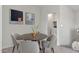 Cozy dining space featuring modern artwork and a view towards the laundry area at 7448 S 75Th Ln, Laveen, AZ 85339