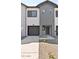 Stylish townhouse featuring a modern design with a gray and white color scheme and attached garage at 7448 S 75Th Ln, Laveen, AZ 85339