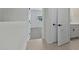 Hallway with access to the bathroom and bedroom at 7448 S 75Th Ln, Laveen, AZ 85339