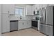 Modern kitchen with stainless steel appliances, white cabinetry, and ample counter space at 7448 S 75Th Ln, Laveen, AZ 85339