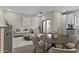 Open concept living and dining area with modern finishes and plenty of natural light at 7448 S 75Th Ln, Laveen, AZ 85339