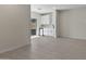 Open living area featuring tile floors, white walls, and a convenient wet bar setup at 7448 S 75Th Ln, Laveen, AZ 85339