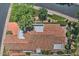 A beautiful aerial view of a home with a red tile roof surrounded by lush greenery at 8120 E Cortez Dr, Scottsdale, AZ 85260