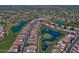Aerial view of a golf course community with well-maintained homes and picturesque lakes at 8120 E Cortez Dr, Scottsdale, AZ 85260