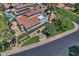 Overhead view of a house with solar panels, tile roof, landscaped yard, and surrounding neighborhood at 8120 E Cortez Dr, Scottsdale, AZ 85260