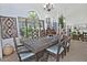 Dining room featuring a large wood table, unique chairs, and large arched windows with natural light at 8120 E Cortez Dr, Scottsdale, AZ 85260