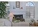 Close-up of the fireplace with decorative items and an arched window, creating a cozy atmosphere at 8120 E Cortez Dr, Scottsdale, AZ 85260