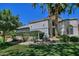 Attractive single-story home with a well-manicured front lawn, palm trees, and neutral color scheme at 8120 E Cortez Dr, Scottsdale, AZ 85260