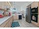 Well-lit kitchen with stainless steel appliances, light cabinets, and a vaulted ceiling at 8120 E Cortez Dr, Scottsdale, AZ 85260