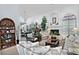 Open living space with neutral walls, large plant, fireplace, and access to the dining room at 8120 E Cortez Dr, Scottsdale, AZ 85260