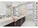 Modern bathroom featuring a marble countertop, dark wood cabinets, and unique floral wallpaper design at 8216 E Angel Spirit Dr, Scottsdale, AZ 85255