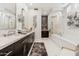 Luxurious bathroom with dual vanities, a soaking tub, walk-in shower, and elegant finishes at 8216 E Angel Spirit Dr, Scottsdale, AZ 85255