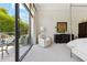 Bright primary bedroom with a king bed and large glass doors to the backyard pool at 8216 E Angel Spirit Dr, Scottsdale, AZ 85255