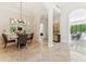 Dining room with marble floors, chandelier, and views of the adjacent living spaces at 8216 E Angel Spirit Dr, Scottsdale, AZ 85255