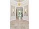 Elegant foyer with marble flooring, decorative sconces, and an ornate chandelier at 8216 E Angel Spirit Dr, Scottsdale, AZ 85255