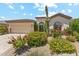 Charming single-story home showcasing desert landscaping, a two-car garage and elegant architectural details at 8216 E Angel Spirit Dr, Scottsdale, AZ 85255