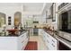 Contemporary kitchen featuring white cabinets, stainless steel appliances, wine fridge, and island with seating at 8216 E Angel Spirit Dr, Scottsdale, AZ 85255