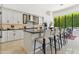 Bright kitchen features an island with bar stool seating, white cabinetry, and high-end stainless steel appliances at 8216 E Angel Spirit Dr, Scottsdale, AZ 85255