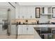 This modern kitchen is complete with stainless steel appliances, white cabinets, and elegant black countertop at 8216 E Angel Spirit Dr, Scottsdale, AZ 85255
