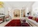Open-concept living area featuring marble floors, neutral paint, a patterned red rug, and modern furnishings at 8216 E Angel Spirit Dr, Scottsdale, AZ 85255