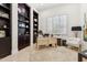 Inviting home office with built-in bookshelves, plantation shutters, and neutral decor at 8216 E Angel Spirit Dr, Scottsdale, AZ 85255