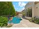 Inviting backyard featuring a pool, mature landscaping, and a cozy patio area at 8216 E Angel Spirit Dr, Scottsdale, AZ 85255