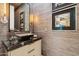 Stylish powder room with textured wallpaper, marble countertop, and unique fixtures at 8216 E Angel Spirit Dr, Scottsdale, AZ 85255