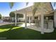 Inviting backyard features a covered patio, outdoor bar, and lush artificial grass at 922 S Ember Cir, Mesa, AZ 85208