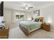 Comfortable bedroom with a ceiling fan, natural light, and carpet flooring at 922 S Ember Cir, Mesa, AZ 85208