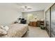 Cozy bedroom with a ceiling fan, closet, and space for a desk or sitting area at 922 S Ember Cir, Mesa, AZ 85208