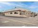 Exterior of the community clubhouse featuring outdoor seating and golf cart parking at 922 S Ember Cir, Mesa, AZ 85208