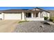 Charming front exterior featuring a well-manicured yard, covered porch, and two-car garage at 922 S Ember Cir, Mesa, AZ 85208