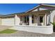 Inviting front exterior with a cozy porch, well-kept landscaping, and attached two-car garage at 922 S Ember Cir, Mesa, AZ 85208
