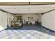 Spacious garage featuring a golf cart, ample storage cabinets, and a stylish blue and beige tiled floor at 922 S Ember Cir, Mesa, AZ 85208