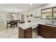 Open kitchen view including bar seating, sink, and stainless steel dishwasher at 922 S Ember Cir, Mesa, AZ 85208