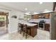 Well-lit kitchen features granite countertops, stainless steel appliances and tiled floors at 922 S Ember Cir, Mesa, AZ 85208