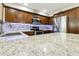 Kitchen with granite countertops, modern backsplash, stainless steel appliances, and wood cabinets at 922 S Ember Cir, Mesa, AZ 85208