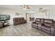 Living room features hardwood floors, a ceiling fan, and a TV, perfect for relaxing or entertaining at 922 S Ember Cir, Mesa, AZ 85208