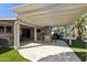 Spacious covered patio with an outdoor kitchen, grill, and ample seating area at 922 S Ember Cir, Mesa, AZ 85208