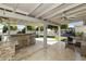 Spacious covered patio with an outdoor kitchen, comfortable seating, and ample room for entertaining at 922 S Ember Cir, Mesa, AZ 85208