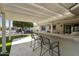 Covered patio with an outdoor bar and comfortable seating area at 922 S Ember Cir, Mesa, AZ 85208