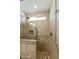Shower featuring neutral-toned tile, a river rock floor, and glass enclosure at 922 S Ember Cir, Mesa, AZ 85208