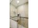 Walk-in shower featuring neutral-toned tile, built-in niche, and glass door at 922 S Ember Cir, Mesa, AZ 85208