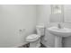 This bathroom has a pedestal sink, toilet, and window at 923 E Agua Fria Ln, Avondale, AZ 85323