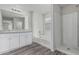 Bright bathroom with dual sink vanity, soaking tub and glass enclosed shower at 923 E Agua Fria Ln, Avondale, AZ 85323