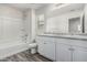 Bright bathroom with granite countertops, modern fixtures, and soaking tub at 923 E Agua Fria Ln, Avondale, AZ 85323