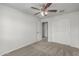 Carpeted bedroom with ceiling fan and closet with doors at 923 E Agua Fria Ln, Avondale, AZ 85323